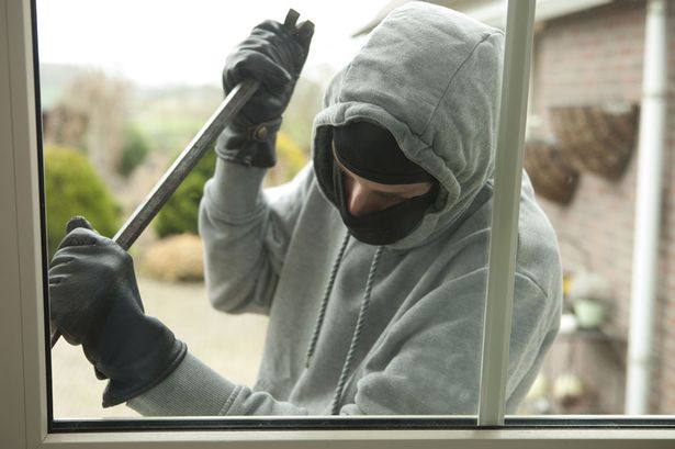 Burglar-with-crowbar-trying-to-enter-house.jpg